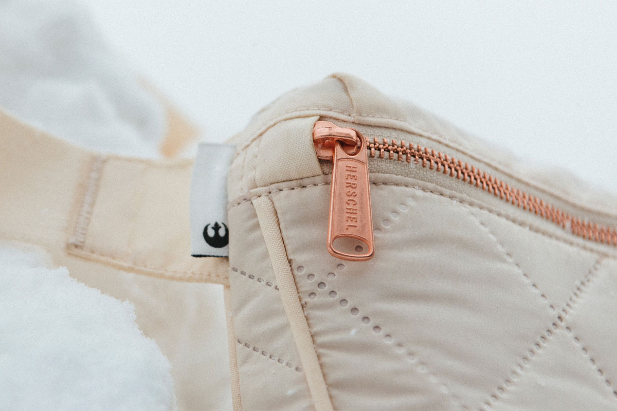 close up shot of the front of the bag showing rose gold zippers and hardware